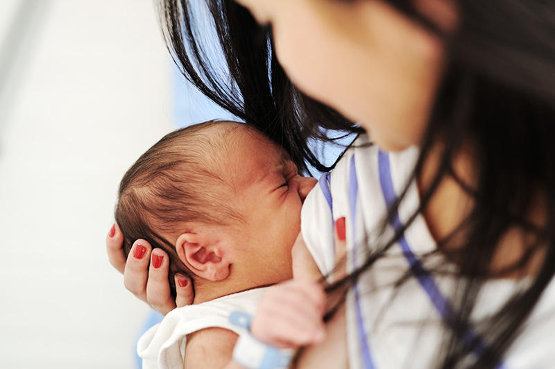 Mother breastfeeding her young son.