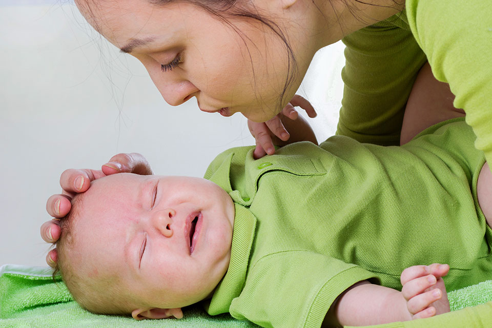 Mother soothing a crying baby.