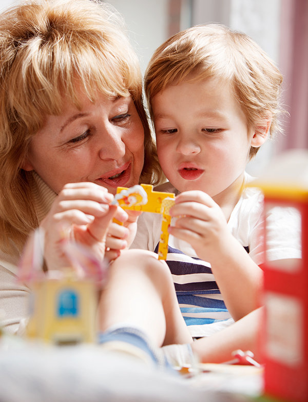 Child care provider screening a child for developmental milestones.